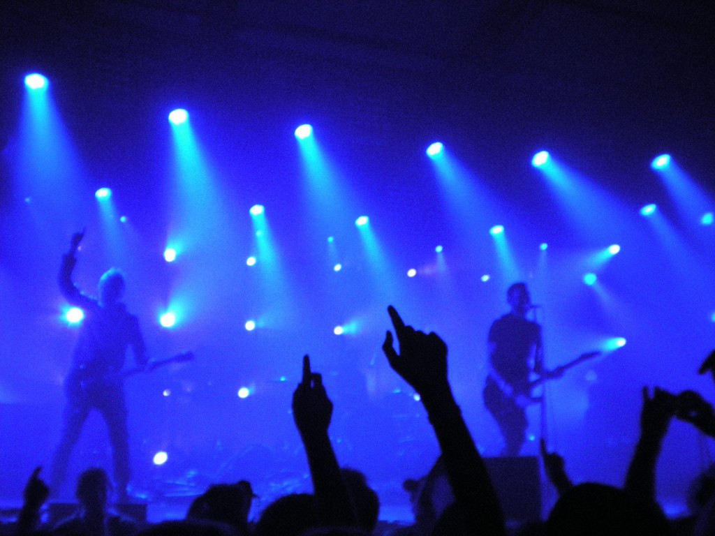 A live band performing under blue lights